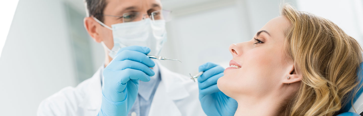 Female patient at dental procedure in modern dental clinic